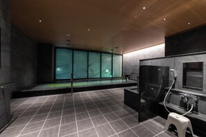 A modern bathroom with a large bathtub, a shower area, and a glass-enclosed window. - Hotel Vista Fukuoka Nakasu-Kawabata (Fukuoka)