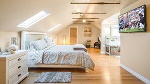 A bedroom with a bed, bedside table, dresser, and a large window. - The most beautiful home in Historic East Side of Kalispell. @whitehouse_project  (Kalispell)