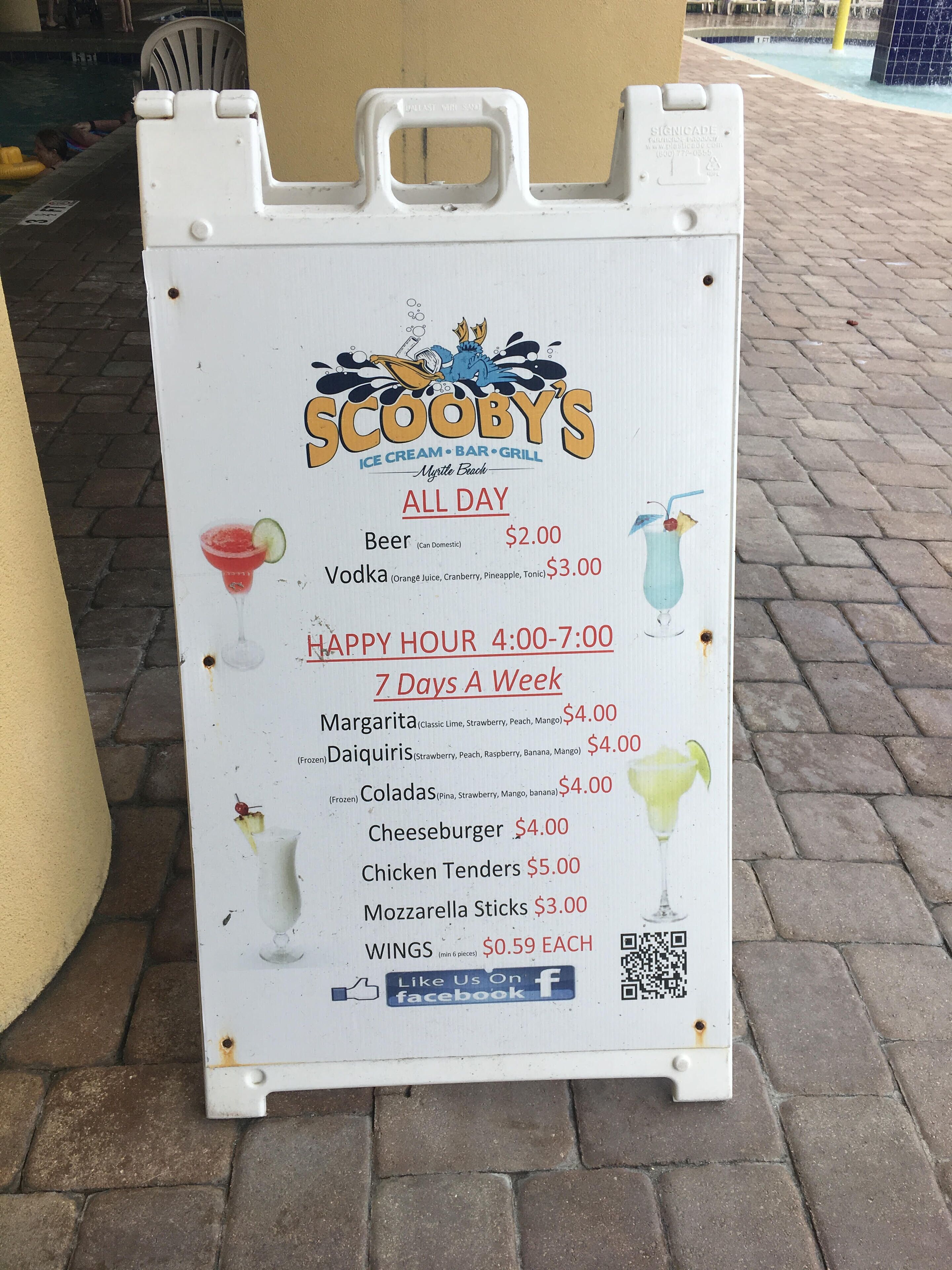 A menu board for Scooby's Ice Cream Bar & Grill, listing prices for drinks and food items.