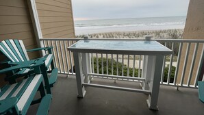A balcony with a view of the beach and ocean. - Enjoy an oceanfront getaway with beautiful beach steps from your door.   (North Topsail Beach)