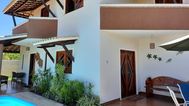 A two-story house with a covered patio, a swimming pool, and outdoor furniture. - Beach House in Guarajuba, North Coast of Bahia (Camaçari)