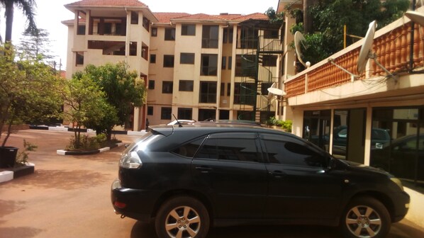 Stylish building with multiple balconies and large windows, offering ample natural light and a landscaped environment.