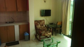 Cozy living space with a kitchenette, dining area, and comfortable seating for two.