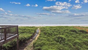 A pathway leading to a beach with a wooden fence on one side. - Fabulous Find - Spendlove Oceanfront (Duck)