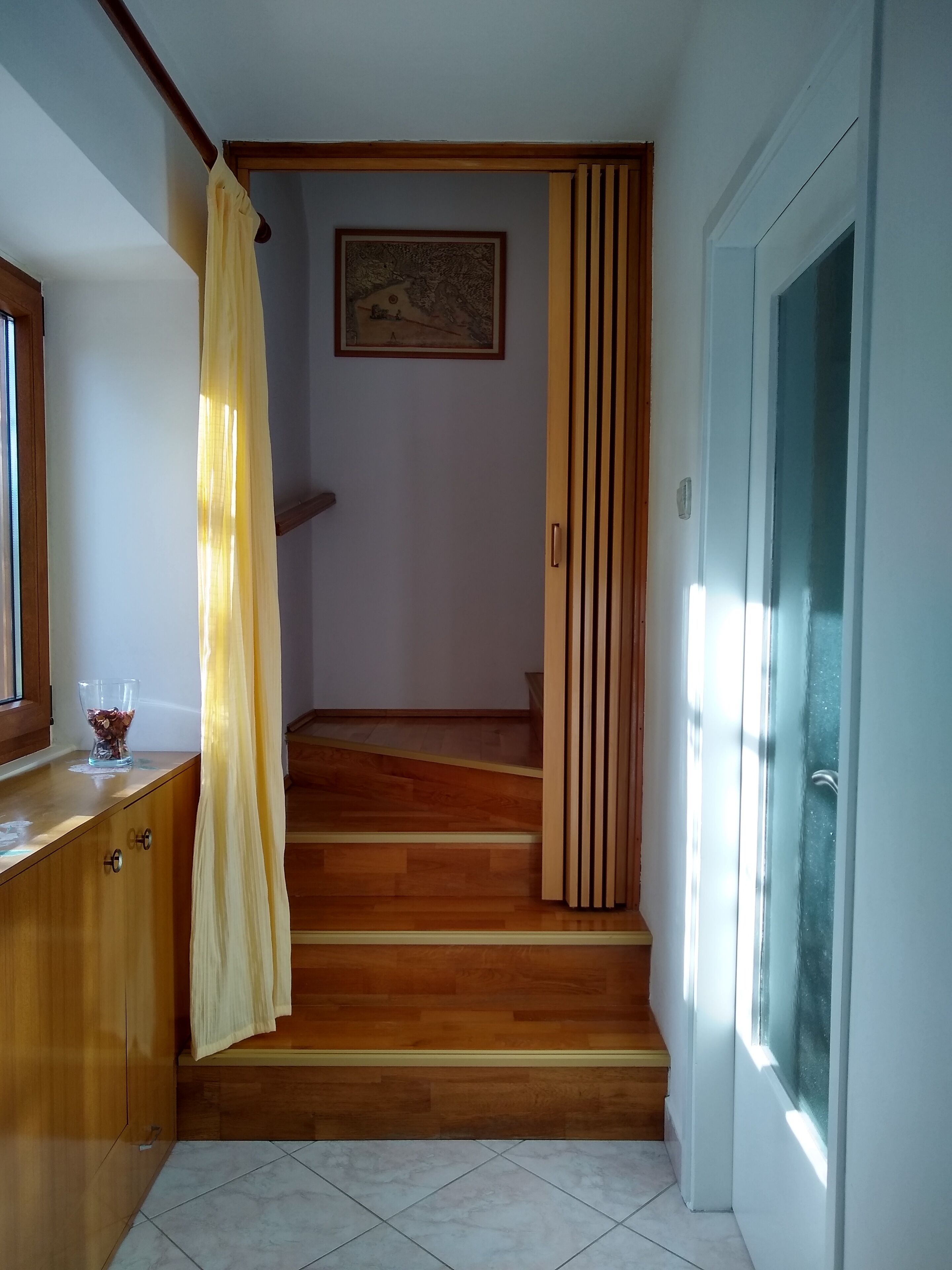 A staircase with wooden steps leading to a landing.