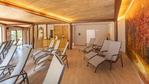 A spacious room with a wooden ceiling, a reception desk, and several lounge chairs arranged for guests. - Anticheterme / Trilocale (Sorano GR)