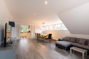 Exclusive Penthouse, Multiple Beds, Valley View | Living area | 50-inch flat-screen TV with satellite channels, LED TV, heated floors - Townus Apartments Wiesbaden (Wiesbaden)