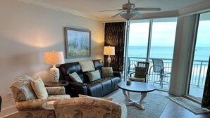 A living room with a sofa, armchairs, a coffee table, and a painting on the wall. - MVG 511 3 bedroom 3 bath Oceanfront (North Myrtle Beach)