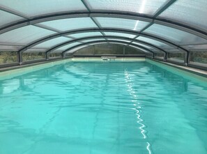 Swimmers can enjoy a refreshing dip in this clean, well-maintained pool surrounded by a curved roof.