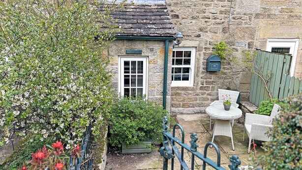 A stone building with a small garden, a mailbox, and a chair outside. - 2 bedroom accommodation in Bewerley, near Pateley Bridge (Bewerley, near Pateley Bridge)