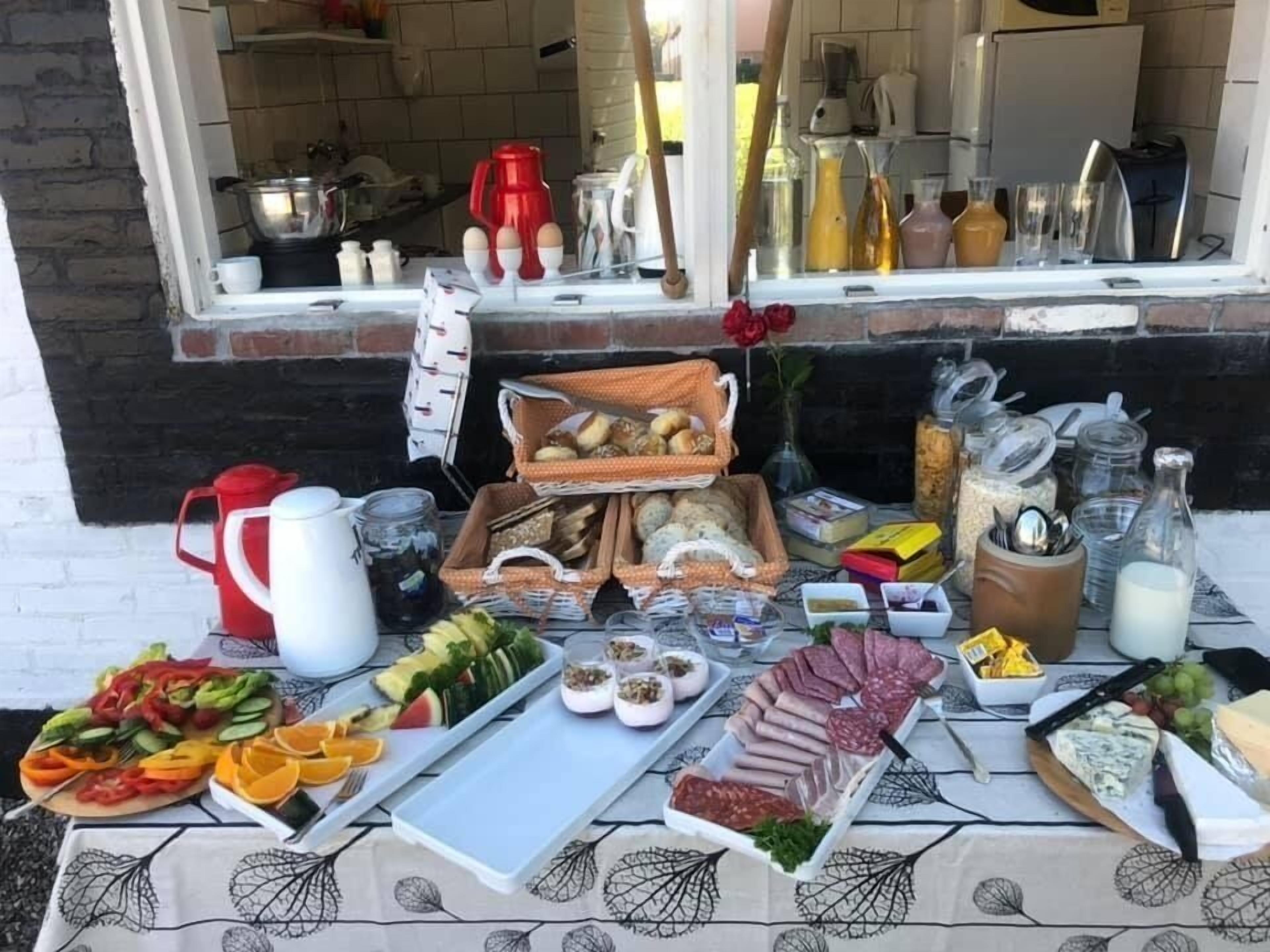 A breakfast buffet with various food items and condiments.