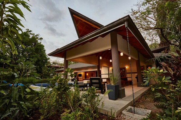 A modern house with a covered patio, a pool, and lush greenery. - Hermandad, Short Walk to Surfing Beach | Family Retreat, Gorgeous 4 BDR home located very close to the Beach Dog Cafe  (Nosara)