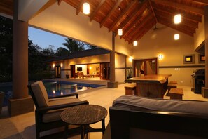 An outdoor pool area with lounge chairs and a bar. - Hermandad, Short Walk to Surfing Beach | Family Retreat, Gorgeous 4 BDR home located very close to t... (Nosara)
