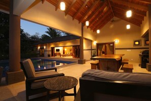 An outdoor pool area with lounge chairs and a bar. - Hermandad, Short Walk to Surfing Beach | Family Retreat, Gorgeous 4 BDR home located very close to the Beach Dog Cafe  (Nosara)