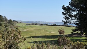 A golf course with a clear view of the sea and distant hills. - 2 bedroom accommodation in Carlyon Bay, near St Austell (Carlyon Bay, near St Austell)