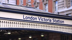 The exterior of London Victoria Station with a prominent station sign. - The Eaton Townhouse (London)
