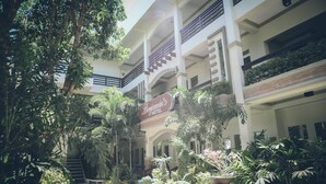 A hotel with a sign reading "Benjamin's Hotel" surrounded by lush greenery and a multi-level building structure. - Villa Esmeralda Bryan's Resort Hotel and Restaurant (Palayan City)