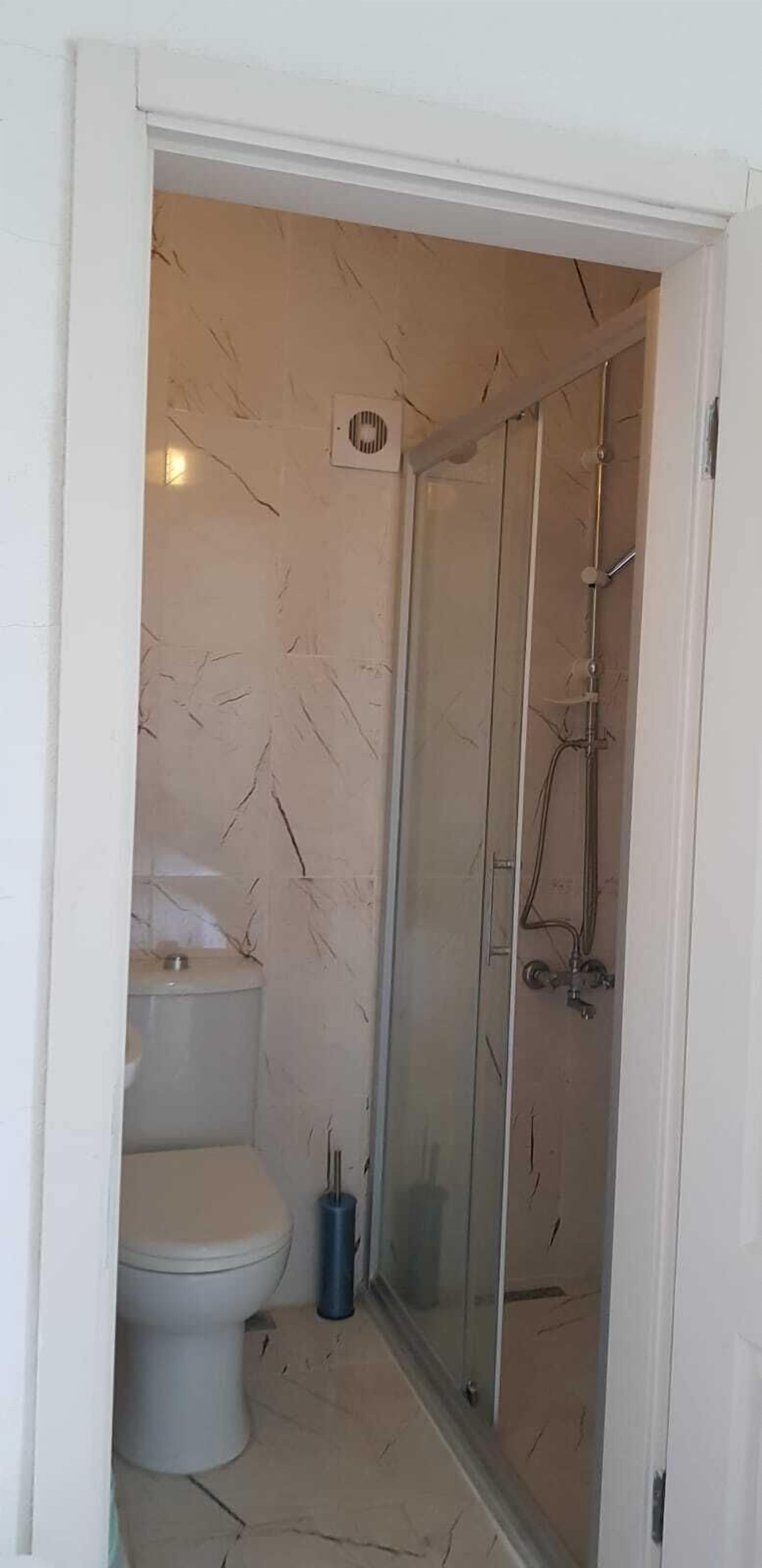 Shower, slippers, towels, toilet paper