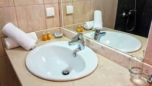 A bathroom with two sinks, a mirror, a towel, and a glass. - Dhermi Lighthouse (Dhërmi)