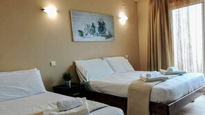 A hotel room with two beds, a painting on the wall, and a window with curtains. - Dhermi Lighthouse (Dhërmi)