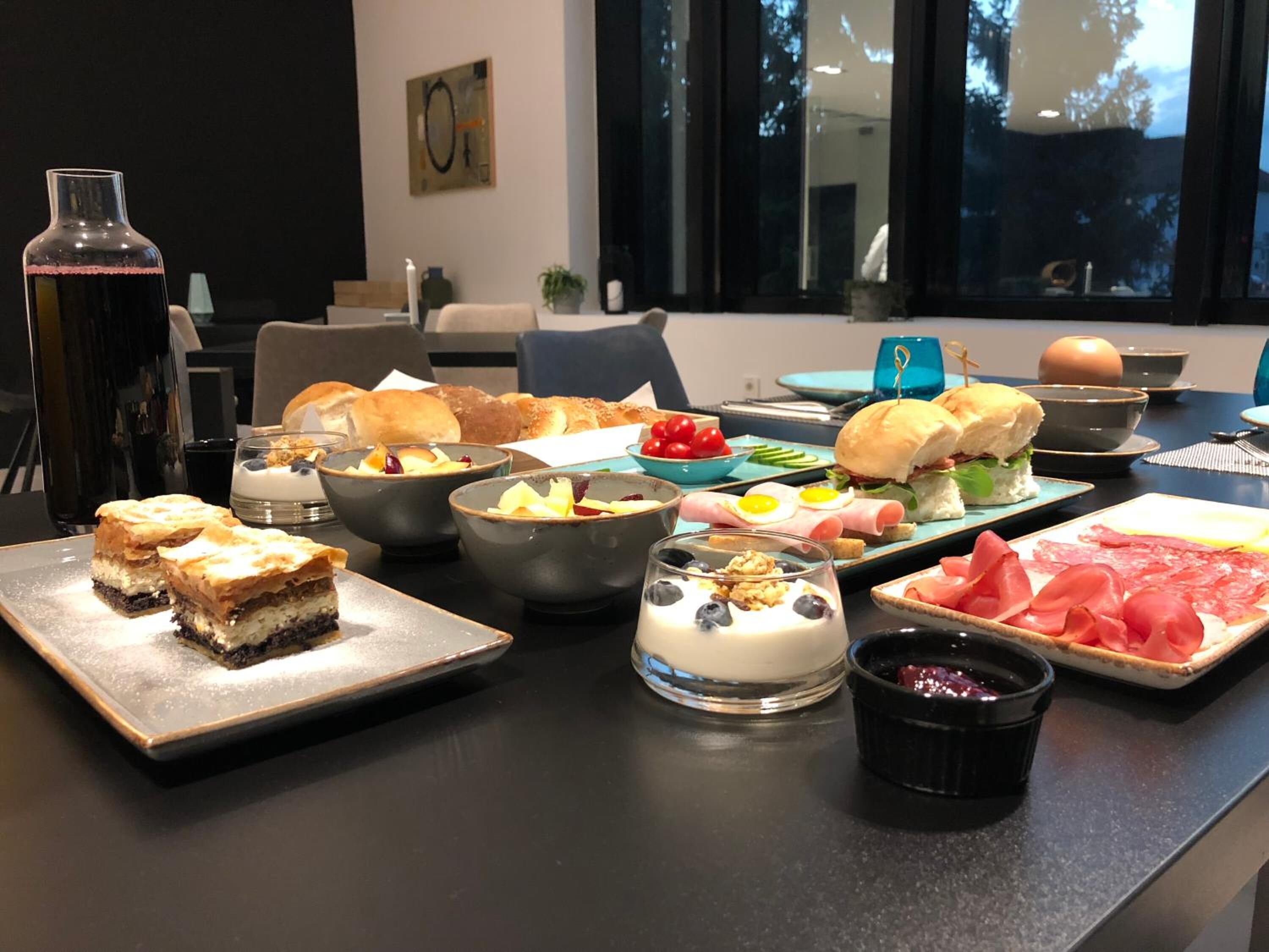 A buffet table with various dishes including pastries, salads, and meats.