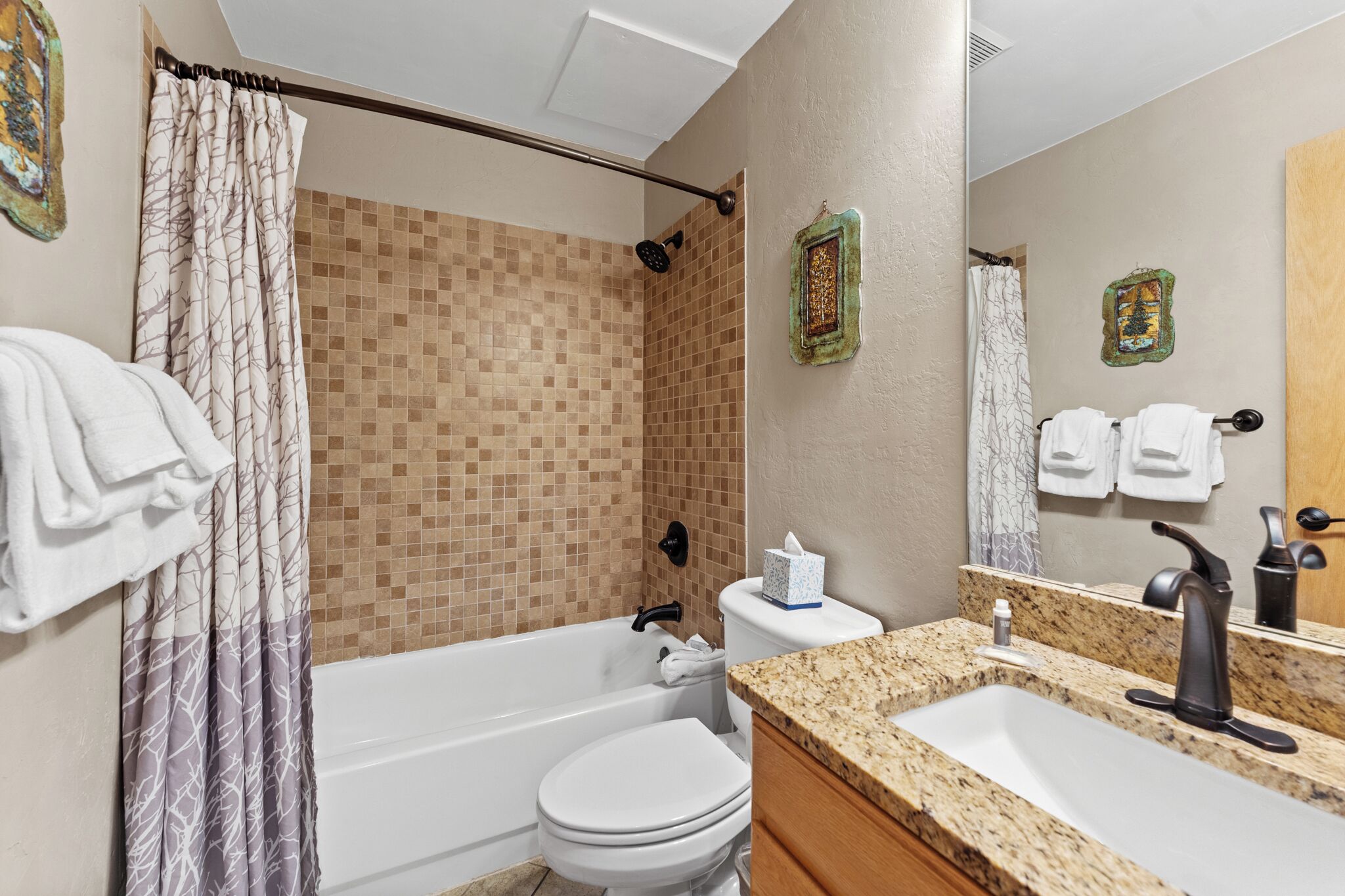 Une salle de bain équipée d’une baignoire, de toilettes, d’un lavabo et d’une douche.