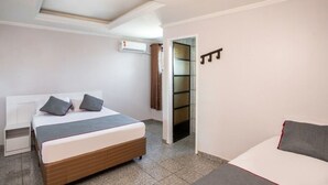A modern bedroom with a bed, bedside tables, and a wardrobe.
