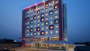 A multi-story hotel with a prominent 'favehotels.com' sign, large windows, and a modern architectural design.