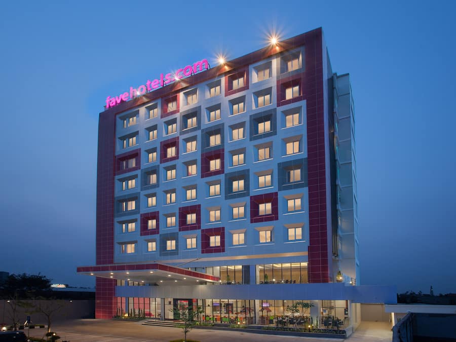 A multi-story hotel with a prominent 'favehotels.com' sign, large windows, and a modern architectural design.