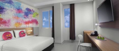 A modern hotel room with a large bed, a desk with a chair, a flat-screen TV, and a colorful abstract painting on the wall.