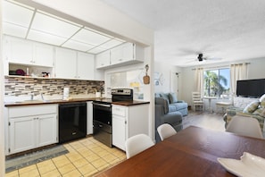 Cozy living space with a kitchenette, dining area, and comfortable seating for relaxation.
