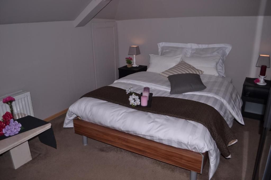 A bedroom with a bed, bedside tables, a bench, and a radiator.