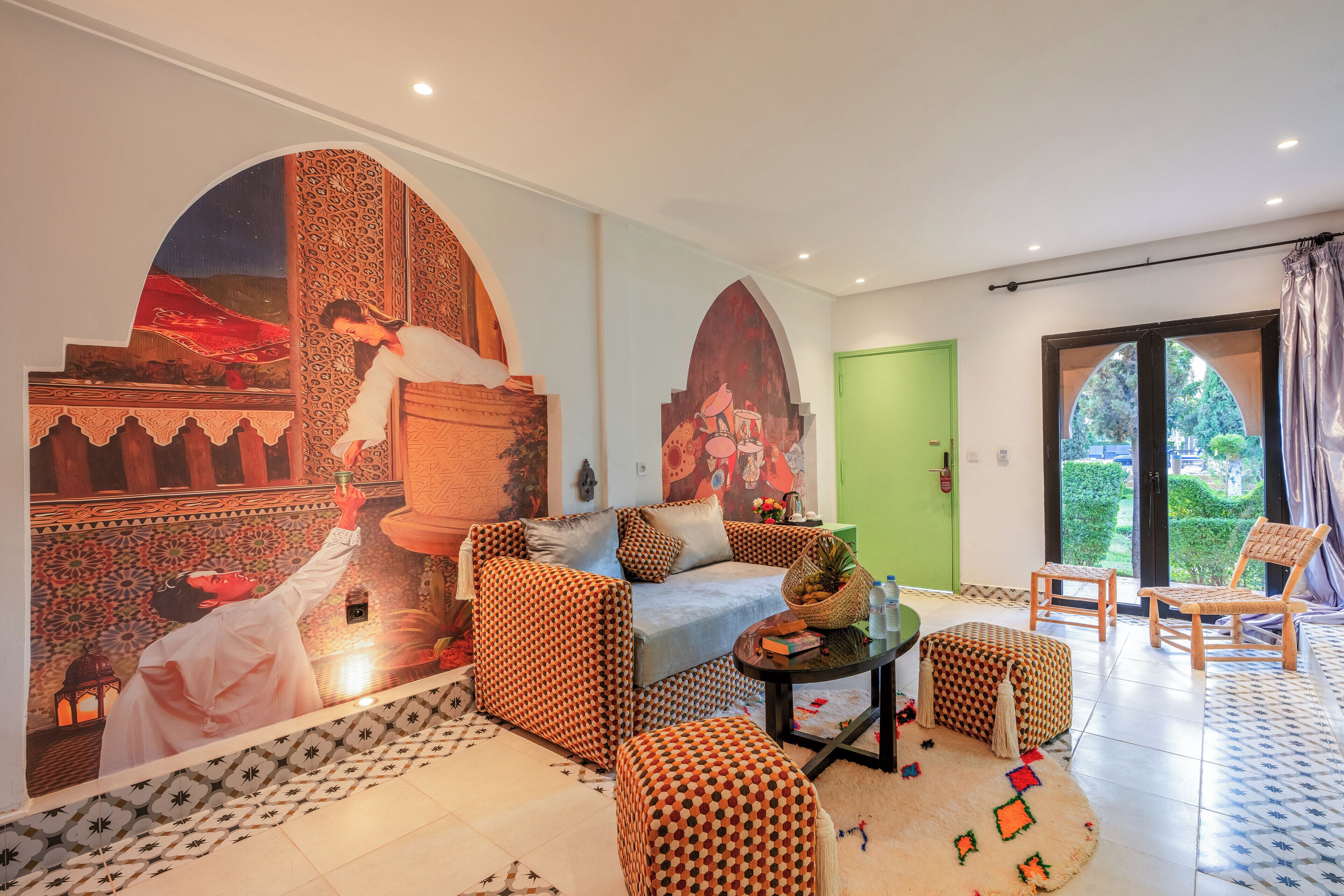 A living room with patterned sofas, a coffee table, and a green door.