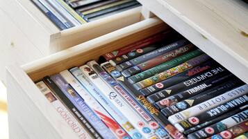 Een lade gevuld met dvd's en boeken, waaronder titels als 'The Lord of the Rings' en 'The Hobbit'.