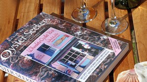 A magazine titled "Oyster Seekers" on a wooden table. - 2 bedroom accommodation in Whitstable (Whitstable)