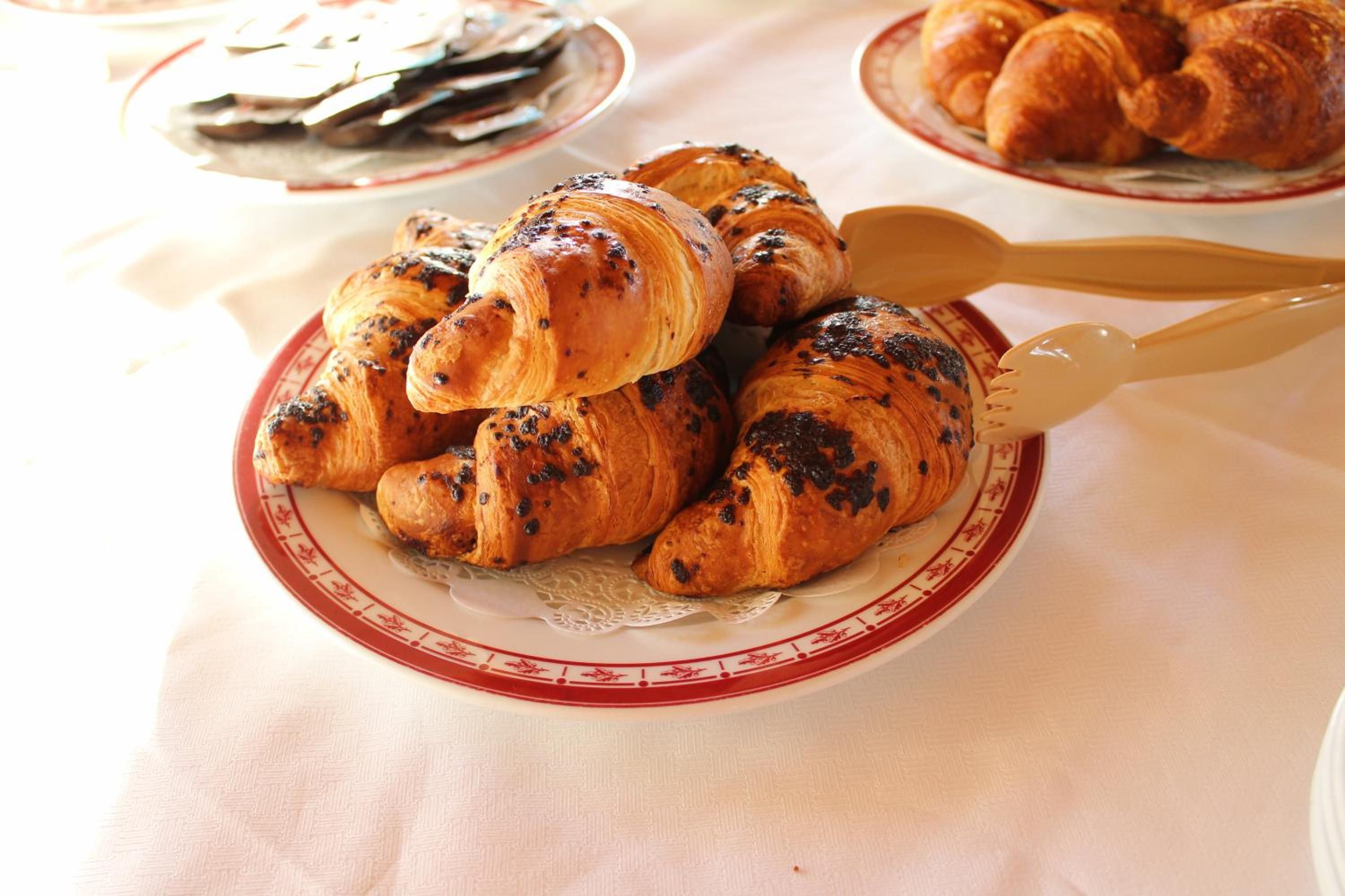 A plate of croissants on a table.
