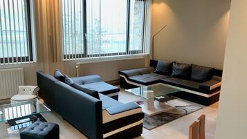Family Apartment, 3 Bedrooms, Kitchen, Lake View (Les Trois Lions) | Living room | 49-inch flat-screen TV with cable channels, Smart TV