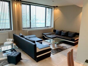 Family Apartment, 3 Bedrooms, Kitchen, Lake View (Les Trois Lions) | Living room | 49-inch flat-screen TV with cable channels, Smart TV