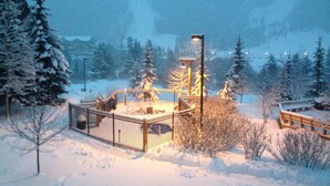 A snow-covered outdoor area with a metal fence, benches, and a lamp post. - Walk to Mountain House, Great Slope Views, Private Laundry, Shared Hot Tubs (Keystone)