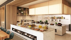 A modern kitchen with a marble island, wooden cabinets, and a variety of food items. - Novotel Bur Dubai (Dubai)