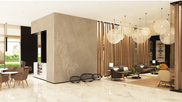 A modern living room with a large sectional sofa, a coffee table, and a dining area with chairs and a table. There are decorative lights hanging from the ceiling and a large window providing natural light. - Novotel Bur Dubai (Dubai)