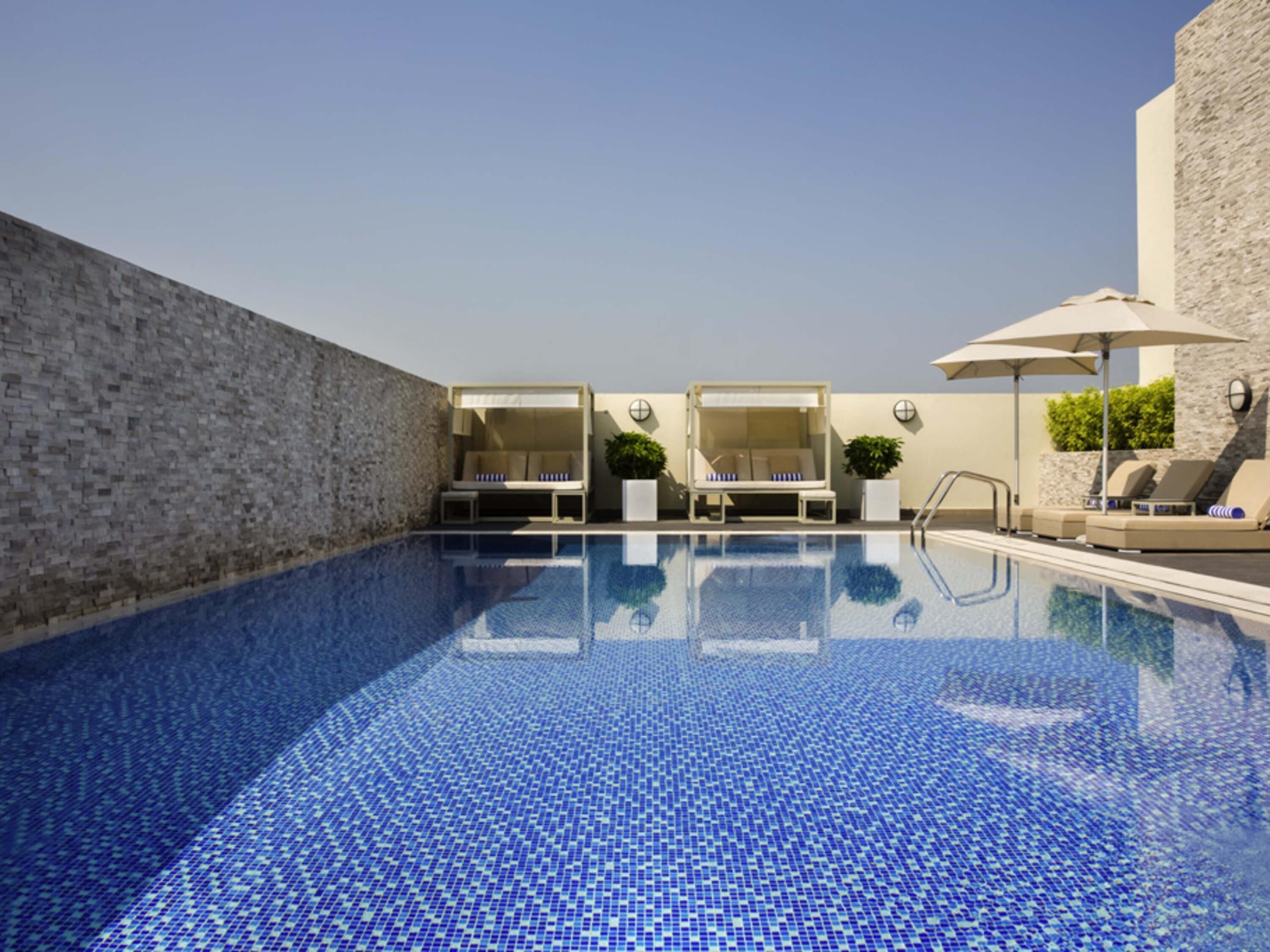 2 outdoor pools, open 6:00 AM to 10:00 PM, pool loungers