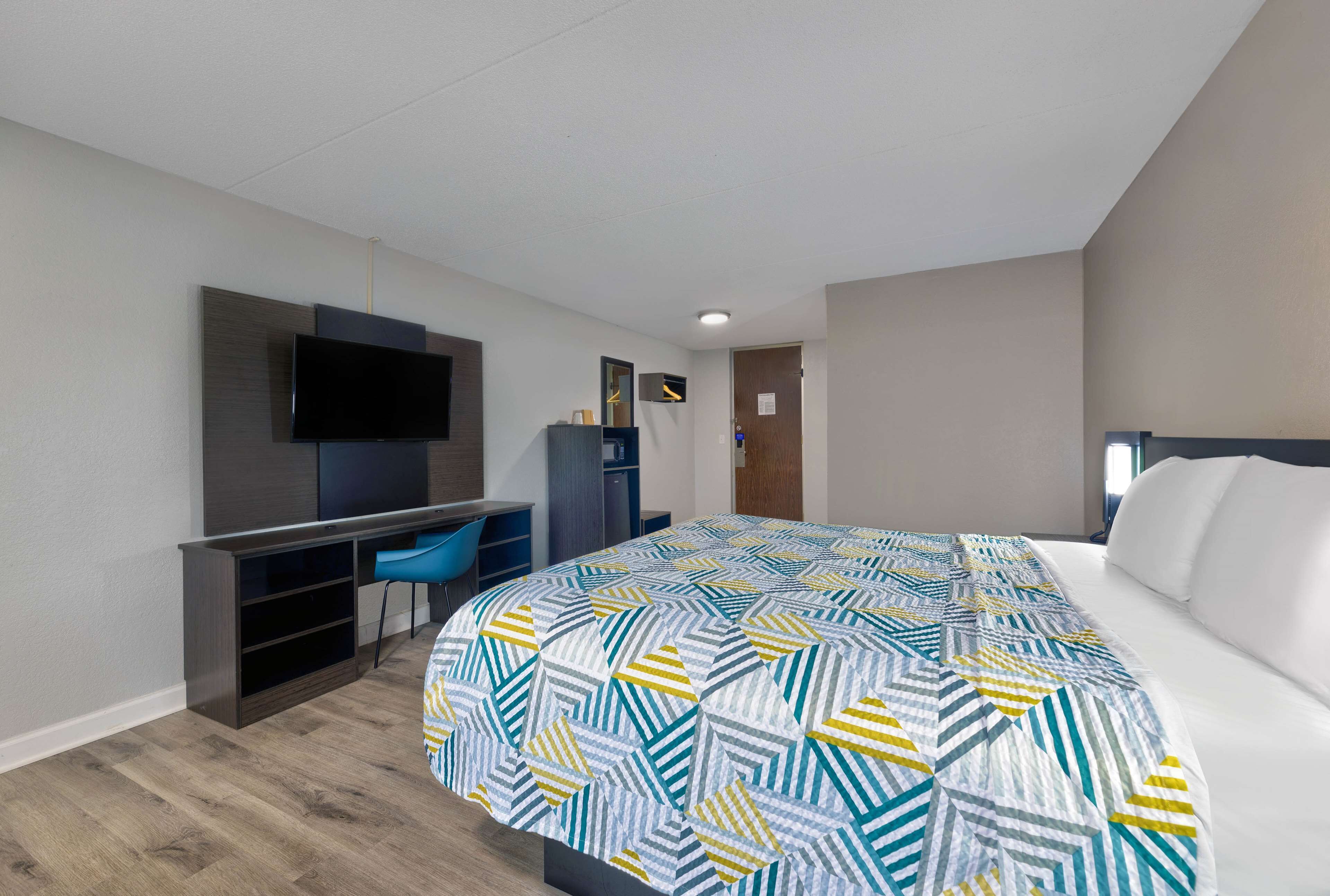 Premium bedding, desk, laptop workspace, blackout drapes