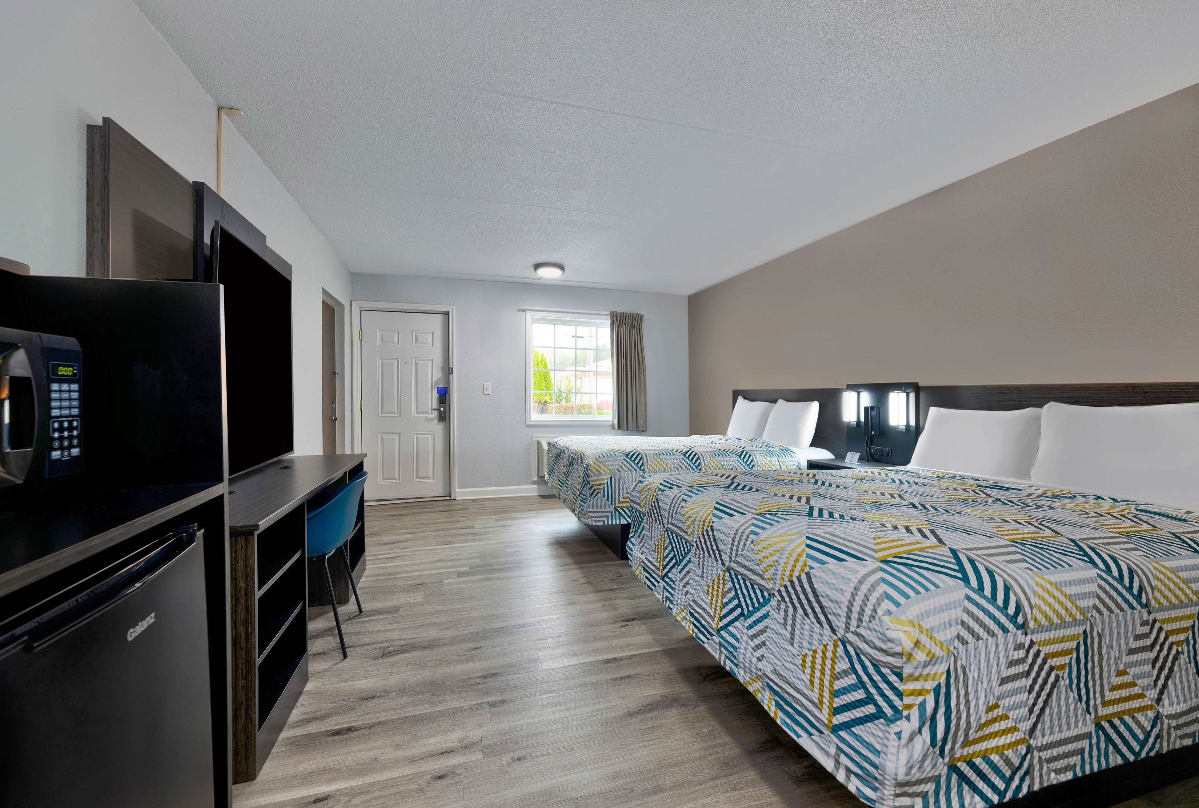 Premium bedding, desk, laptop workspace, blackout drapes