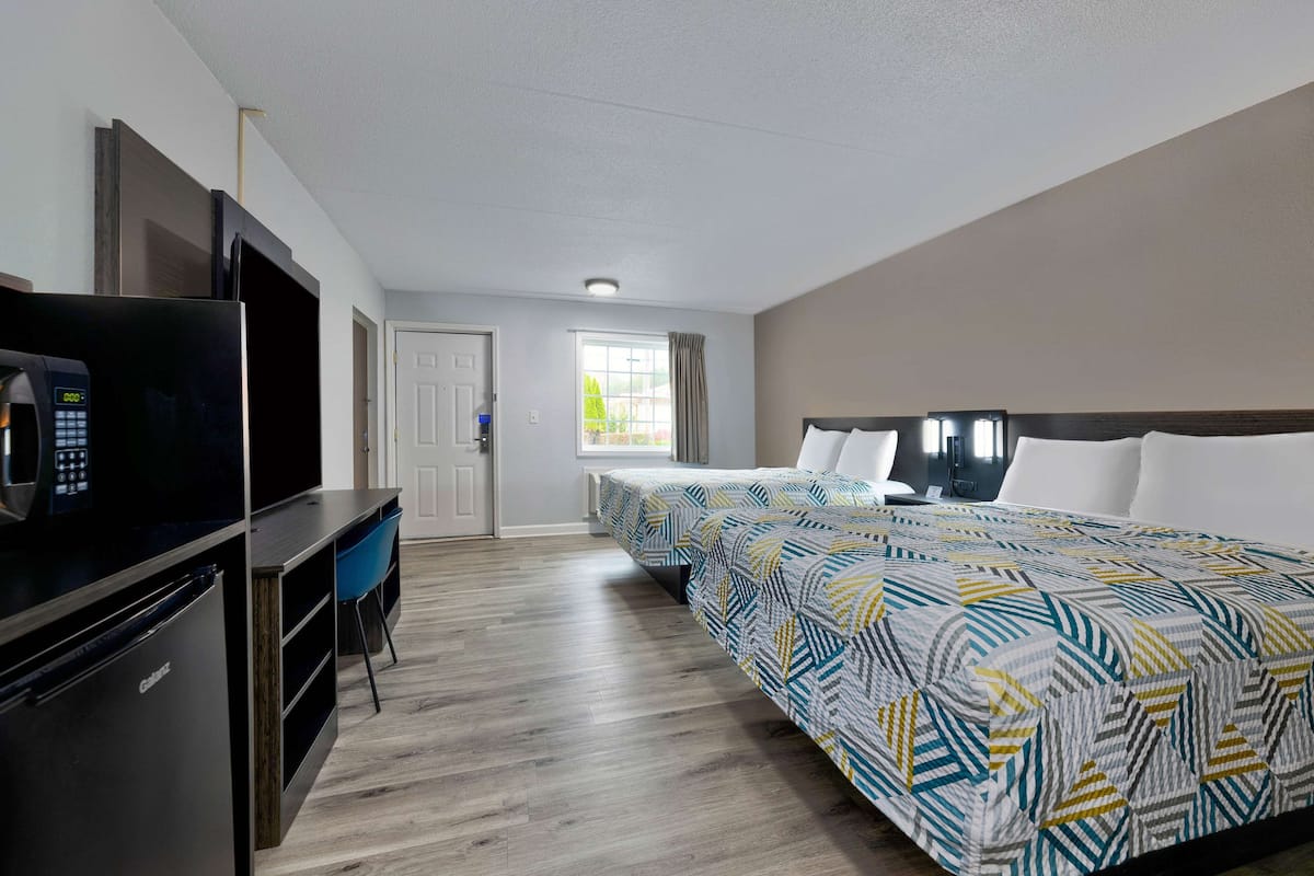 Premium bedding, desk, laptop workspace, blackout drapes