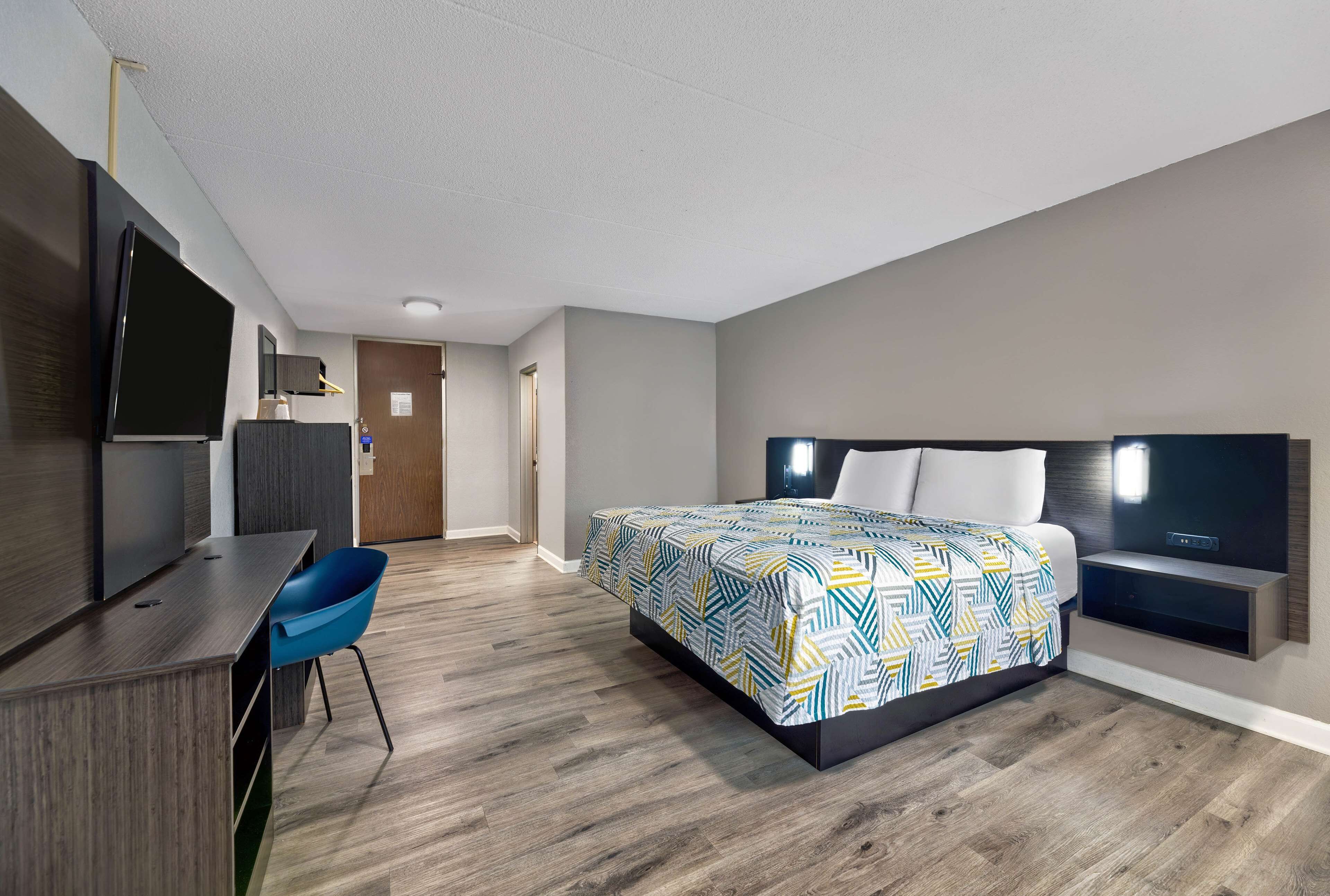 Premium bedding, desk, laptop workspace, blackout drapes