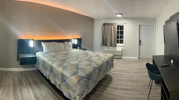 Premium bedding, desk, laptop workspace, blackout drapes