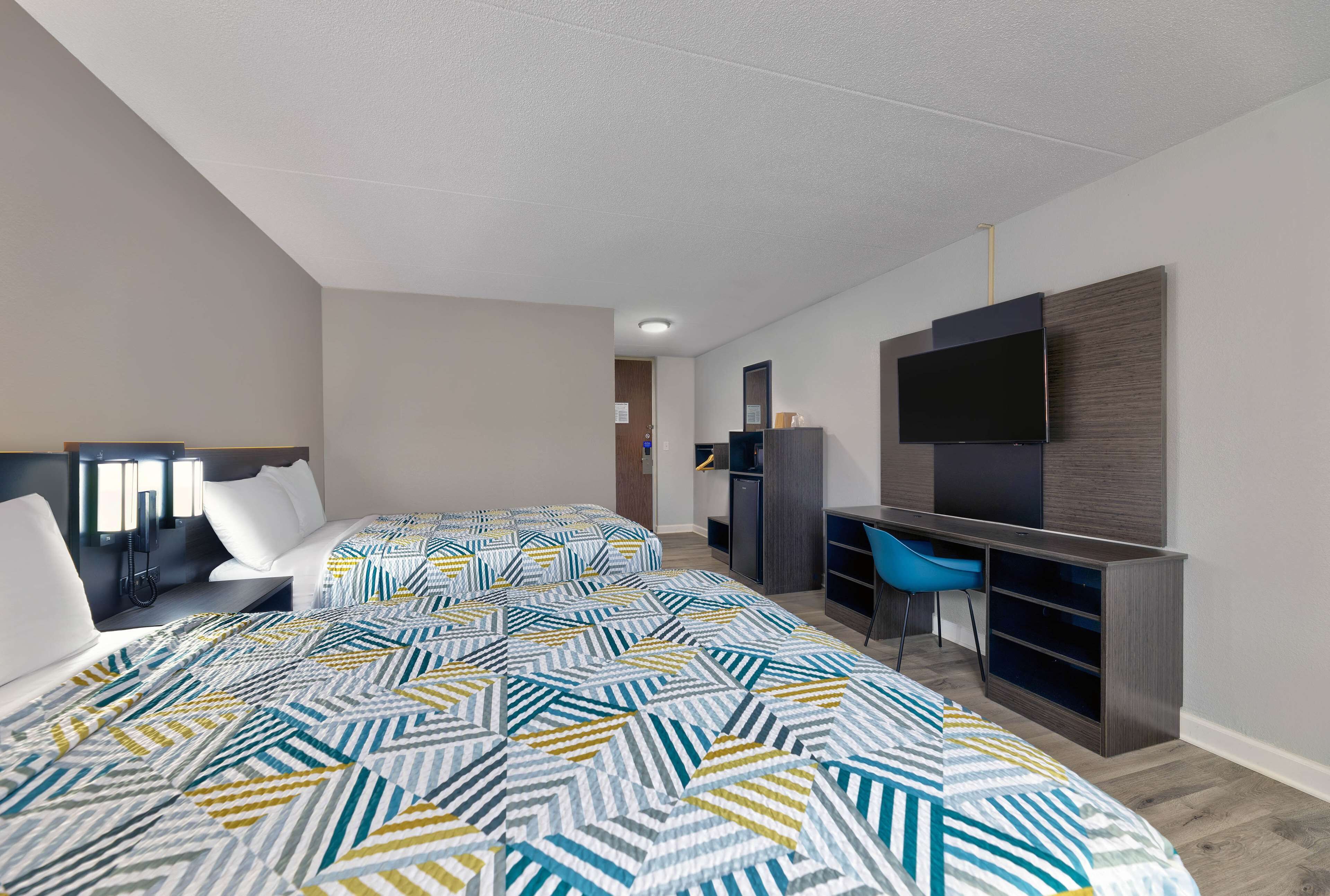 Premium bedding, desk, laptop workspace, blackout drapes