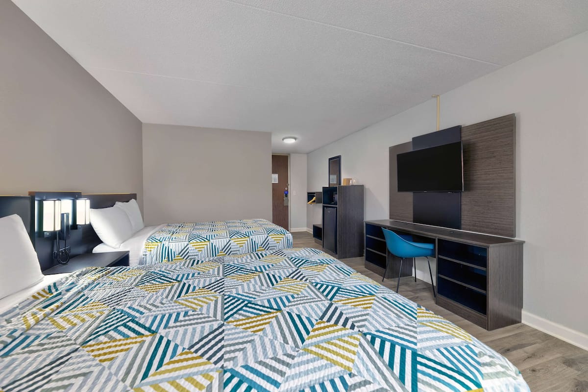 Premium bedding, desk, laptop workspace, blackout drapes