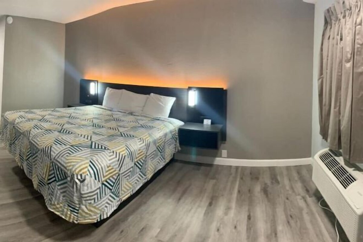 Premium bedding, desk, laptop workspace, blackout drapes